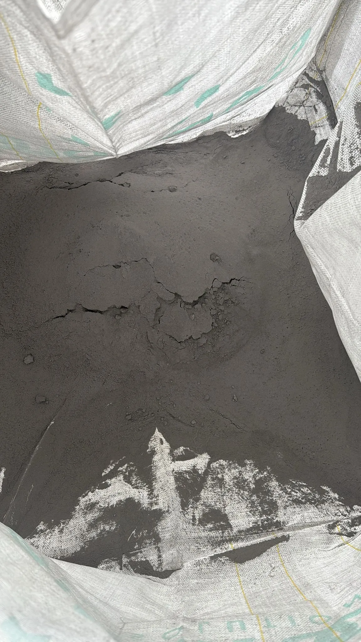 Grey powder at the bottom of a large open bag